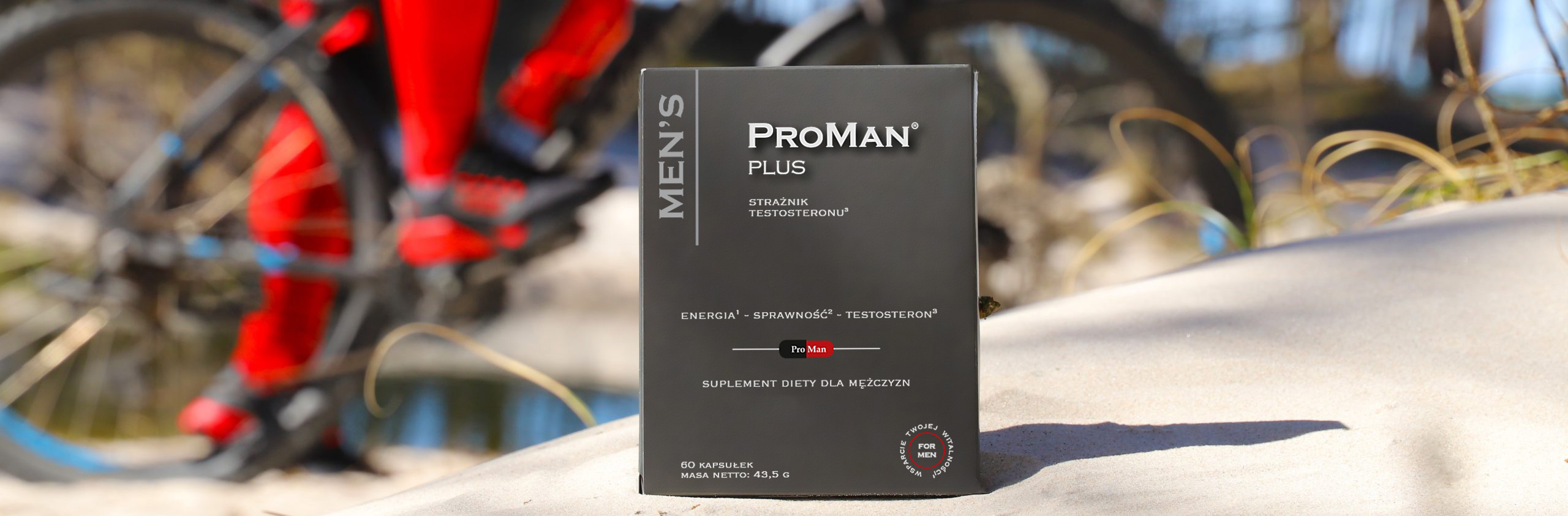 Opakowanie ProMan Plus na tle roweru